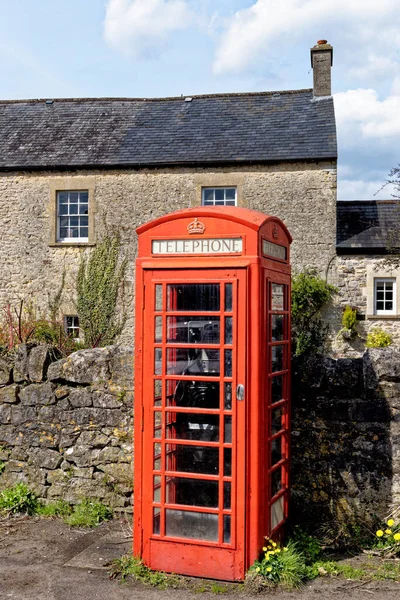 Old english phone boot in the Village of Nunney in a sunny day, Somerset, England, United Kingdom - 8th of April 2023
