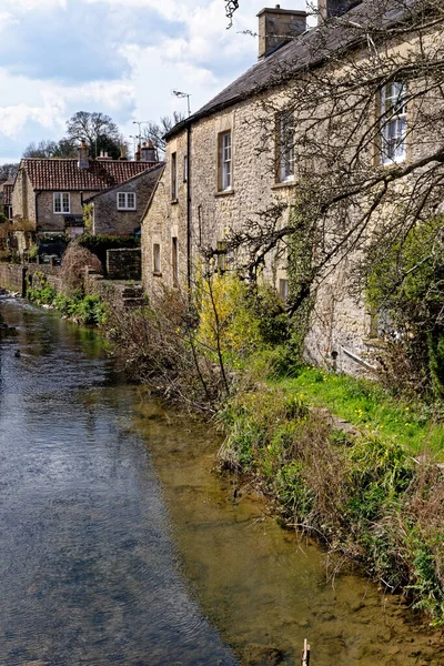 stock image Pretty cottages and the Mells River at Nunney. Village of Nunney, Somerset, England, United Kingdom - 8th of April 2023