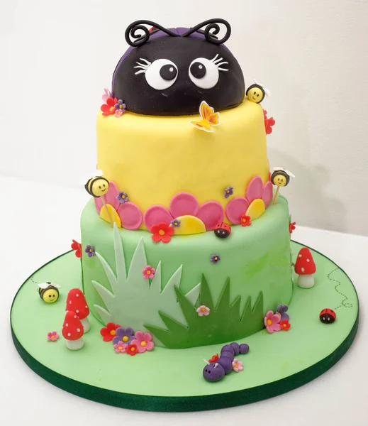 Animal figurine Birthday party cake - Pastel colourful birthday cake. Festive cake with a colourful marzipan