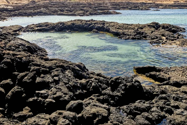 Natural tidal pools of The Playa de los Charcos beach - Natural Pools of Los Laguitos Beach or Los Charcos on Fuerteventura, Canary islands, Spain. 24.09.2023