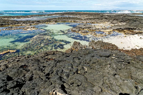 Natural tidal pools of The Playa de los Charcos beach - Natural Pools of Los Laguitos Beach or Los Charcos on Fuerteventura, Canary islands, Spain. 24.09.2023