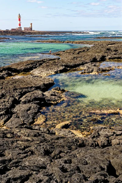 Natural tidal pools of The Playa de los Charcos beach and The Toston Lighthouse - Natural Pools of Los Laguitos Beach or Los Charcos on Fuerteventura, Canary islands, Spain. 24.09.2023