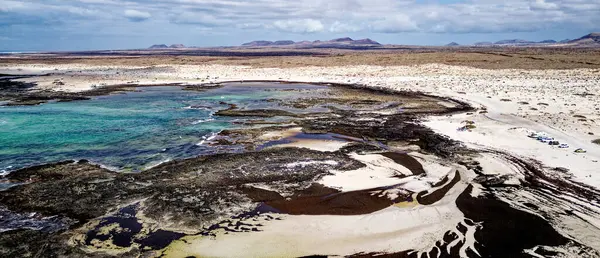 Aerial view of Natural tidal pools of The Playa de los Charcos beach - Natural Pools of Los Laguitos Beach or Los Charcos on Fuerteventura, Canary islands, Spain. 24.09.2023