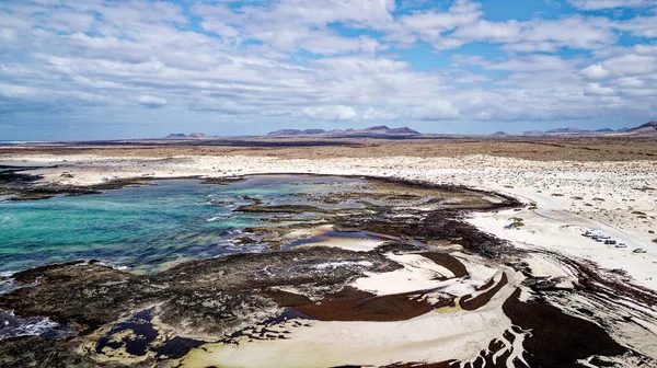 Aerial view of Natural tidal pools of The Playa de los Charcos beach - Natural Pools of Los Laguitos Beach or Los Charcos on Fuerteventura, Canary islands, Spain. 24.09.2023