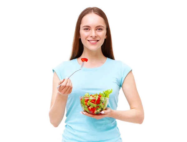 健康的な女性が白い背景に隔離された新鮮なサラダを食べている姿を描いています 食事と健康的な食事の概念 ストックフォト