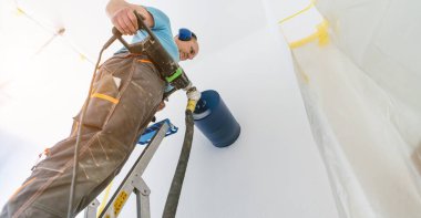 male worker preparing a chimney installation for a modern, energy saving heating stove.