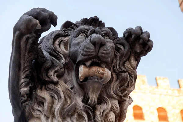 Sculpture of a lion holding a human head in the mouth, located on the Signoria Square, Florence, Tuscany, Italy.