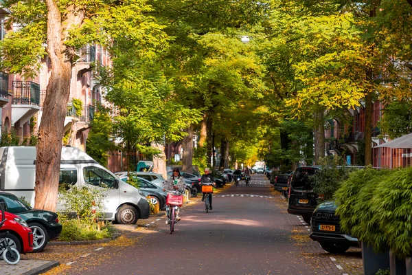 stock image Amsterdam, NL - October 11, 2021: Street view and generic architecture in Amsterdam with typical Dutch style buildings. Amsterdam is one of Europe's most visited tourist destinations.