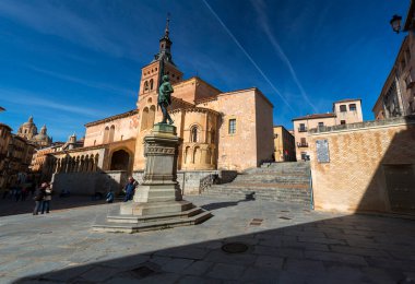Segovia, Spain - February 18, 2022: Plaza Medina del Campo, a historic square that hosts San Martin Church, Las Sirenas de Segovia and Juan Bravo statues. clipart
