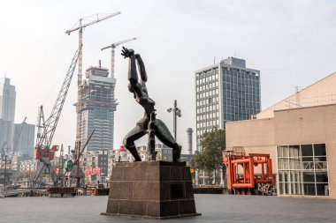 Rotterdam, NL - OCT 10, 2021: The Destroyed City is a bronze memorial sculpture commemorates the German bombing of Rotterdam on 14 May 1940, which destroyed the medieval centre of the city. clipart