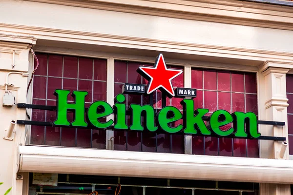 stock image Rotterdam, Netherlands - October 17, 2021: Heineken beer signage at a cafe in Rotterdam, Netherlands, the origin country of the brand.