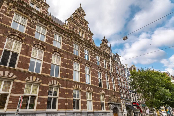 stock image Amsterdam, NL - October 10, 2021: Street view and generic architecture in Amsterdam with typical Dutch style buildings. Amsterdam is one of Europe's most visited tourist destinations.