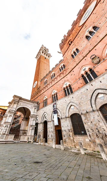 stock image Siena, Italy - APR 7, 2022: The Palazzo Pubblico, town hall is a palace located at the Piazza del Campo, the central square of Siena, Tuscany, Italy.