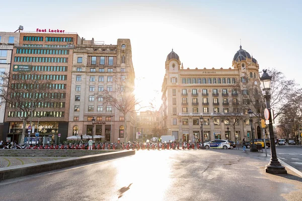 stock image Barcelona, Spain - February 10, 2022: Buildings and people on the move at the Catalonia Square, La Placa de Catalunya in Barcelona, Spain.