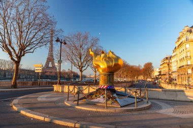 Paris, France - January 24, 2022: The Flame of Liberty is a full-sized, gold leaf covered replica of the torch from the Statue of Liberty, located near the northern end of the Pont de l'Alma, on the Place Diana. clipart