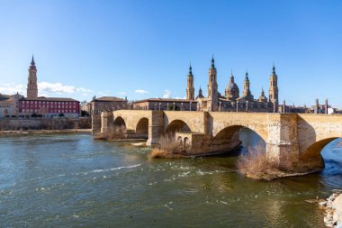 Zaragoza, Spain - February 14, 2022: The Stone Bridge, Puente de Piedra in Spanish, over the River Ebro in Zaragoza, Aragon, Spain. clipart