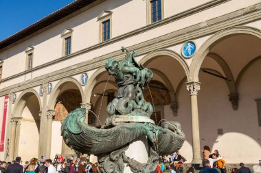 Florence, Italy - April 5, 2022: The Santissima Anunziata Square hosts SS Annunziata Basilica, Hospital of the Innocents and a statue of Ferdinand I of Tuscany. clipart