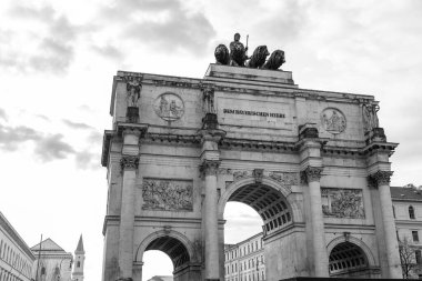 The Siegestor, The Victory Gate in Munich is a three arched memorial arch, crowned with a statue of Bavaria with a lion quadriga. clipart