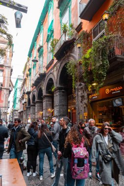 Naples, Italy - April 10, 2022: Via dei Tribunali is a busy and touristic street in the old historic center of Naples, Campania, Italy. clipart
