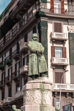 Naples, Italy - April 9, 2022: Bronze statue of the Italian king Umberto I, also knows as Humbert I the Good at the seafront in Via Nazario Sauro, Naples, Italy. clipart