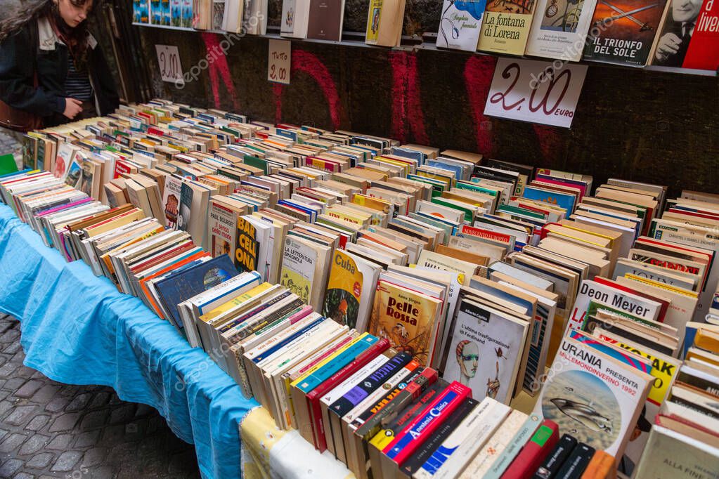 Naples, Italy - APR 9, 2022: Second hand used books for sale on a bookstores stand at the Piazza Gesu Nuovo