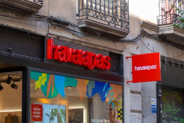 Madrid, Spain - FEB 16, 2022: Havaianas store branch in Chueca, Madrid. Havaianas is a Brazilian brand of flipflop sandals created and patented in 1962. clipart