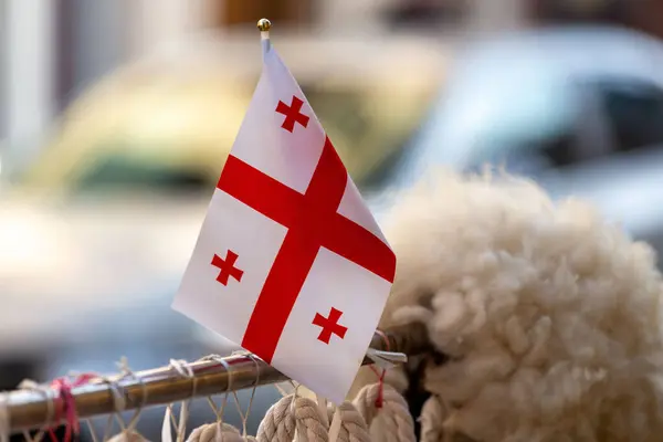 stock image Small Georgian flag with red crosses on white, sold at a souvenir shop in Batumi, Adjara, Georgia.