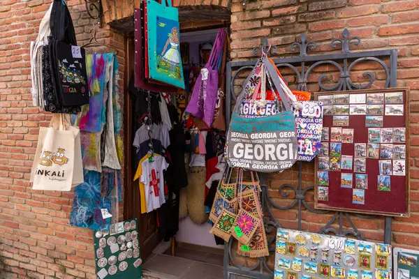 stock image Tbilisi, Georgia - 24 JUNE, 2024: Touristic souvenirs such as printed bags, tshirts, magnets sold at a gift shop in Tbilisi, Georgia.