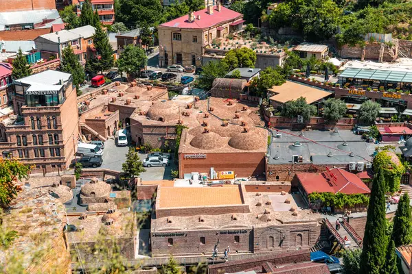 stock image Tbilisi, Georgia - 12 AUG, 2024: Abanotubani meaning the bath district, is the ancient district of Tbilisi, Georgia, known for its sulphuric baths.