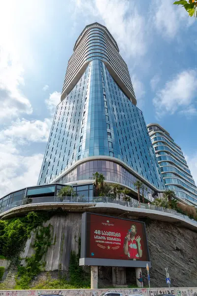 stock image Tbilisi, Georgia - 10 AUG, 2024: King David Residence and Business Center in Tbilisi. A modern building overlooking the Kura River and the Tamar Mepe Bridge.