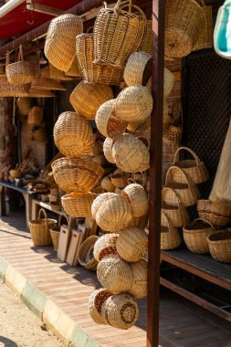 Handmade wicker products displayed in front of a store in Tirilye, Bursa, Turkiye. clipart