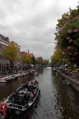 Amsterdam, NL, 10 OCT 2021: Typical Dutch buildings and scenic canals of Amsterdam, the capital of the Netherlands. clipart