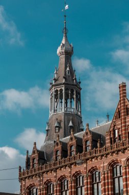 Amsterdam, NL, 10 OCT 2021: The former Amsterdam Main Post Office, now the Magna Plaza shopping centre, is a monumental building in Amsterdam, Netherlands. clipart