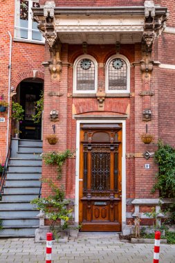 Amsterdam, NL, 10 OCT 2021: Architectural detail from typical Dutch buildings in Amsterdam, the capital of the Netherlands. clipart