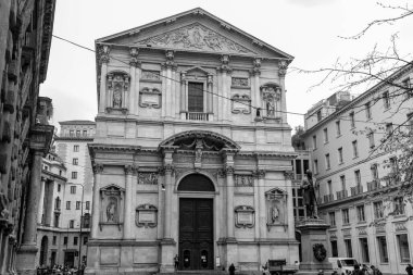 Milan, Italy - 30 March 2022: Piazza San Fedele is situated in the center of Milan, hosting the church of San Fedele, statue of Alessandro Manzoni and Casa Manzoni. clipart