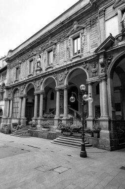 Milan, Italy - 30 March 2022: Piazza Mercanti is a central city square of Milan, between Piazza del Duomo, and Piazza Cordusio. clipart