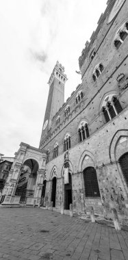 Siena, Italy - APR 7, 2022: The Palazzo Pubblico, town hall is a palace located at the Piazza del Campo, the central square of Siena, Tuscany, Italy. clipart