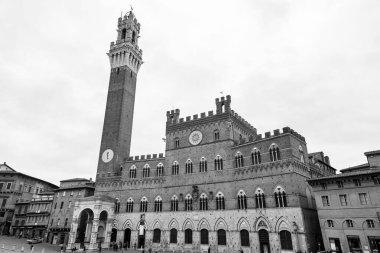 Siena, Italy - APR 7, 2022: The Palazzo Pubblico, town hall is a palace located at the Piazza del Campo, the central square of Siena, Tuscany, Italy. clipart