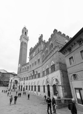 Siena, Italy - APR 7, 2022: The Palazzo Pubblico, town hall is a palace located at the Piazza del Campo, the central square of Siena, Tuscany, Italy. clipart