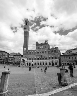 Siena, Italy - APR 7, 2022: The Palazzo Pubblico, town hall is a palace located at the Piazza del Campo, the central square of Siena, Tuscany, Italy. clipart