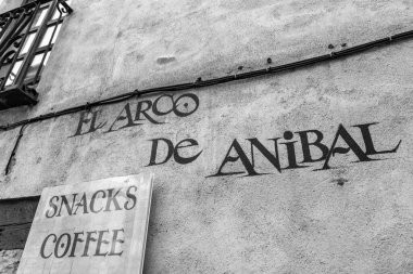 Salamanca, Spain - February 20, 2022: Traditional typographic street name sign in Salamanca, Castile and Leon, Spain. El Arco de Anibal clipart