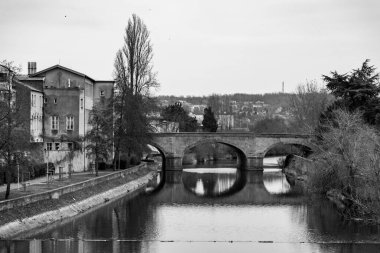 Metz, France - January 23, 2022: Cityscape view from the beautiful city of Metz in France. Bridges, houses and churches on the bank of the Moselle River. Pont St. Marcel. clipart