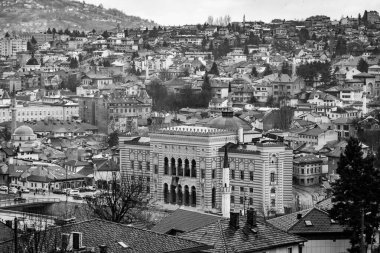 Sarajevo - Bosnia and Herzegovina - 11 FEB 2024: The town hall building of Sarajevo, also the University Library located by the Miljacka River. clipart