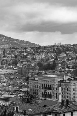 Sarajevo - Bosnia and Herzegovina - 11 FEB 2024: The town hall building of Sarajevo, also the University Library located by the Miljacka River. clipart