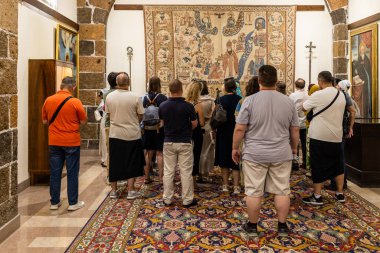 Etchmiadzin, Armenia - June 23, 2024: visitors inside Treasury Museum of Mother See of Holy Etchmiadzin. clipart