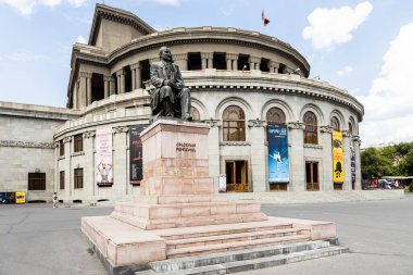 Yerevan, Armenia - July 12, 2024: statue of Hovhannes Tumanyan and Alexander Spendiaryan National Academic Opera and Ballet Theatre in Yerevan city on summer day clipart