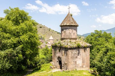 view of Saint Gevorg church and Goshavank monastery in backgrond, in Gosh village, Armenia on sunny summer day clipart