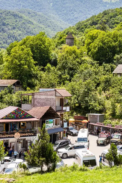 stock image Gosh, Armenia - July 6, 2024: view of car parking area and hotel in Gosh village near Goshavank monastery, Armenia on sunny summer day