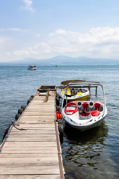 stock image Sevan, Armenia - July 14, 2024: boats near pier of Lake Sevan, Armenia on sunny summer day on Sevan Peninsula