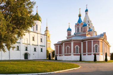 Assumption Cathedral and Church of the Icon of the Mother of God of Tikhvin on Cathedral (Sobornaya) Square of Kolomna Kremlin in Old Kolomna city at summer sunset clipart